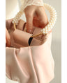 Glossy pearl-handled mini bag with strap