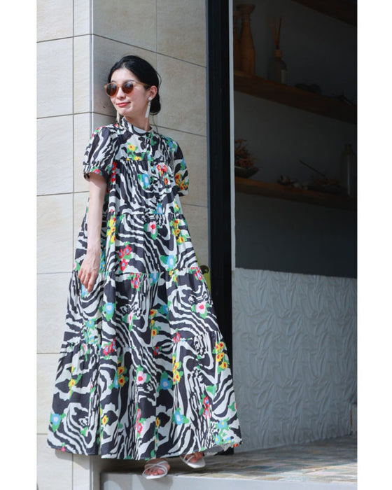 A long dress with a pop floral pattern overlapping with swaying art