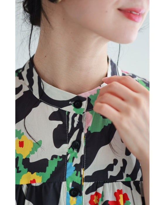 A long dress with a pop floral pattern overlapping with swaying art