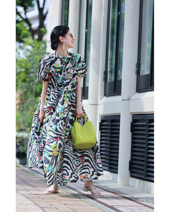 A long dress with a pop floral pattern overlapping with swaying art