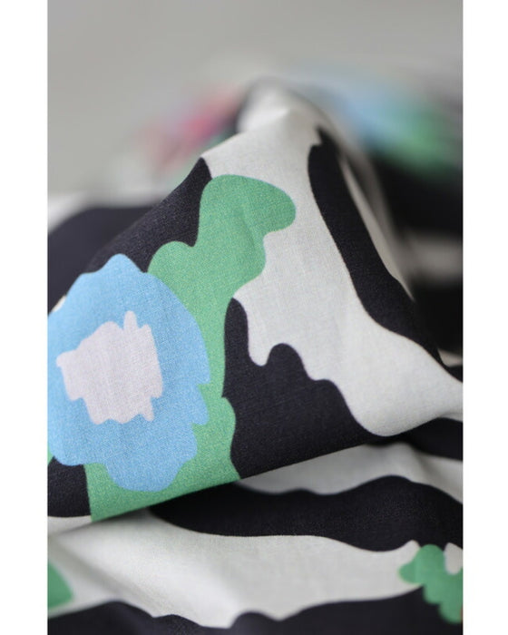A long dress with a pop floral pattern overlapping with swaying art