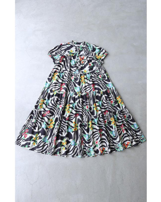 A long dress with a pop floral pattern overlapping with swaying art