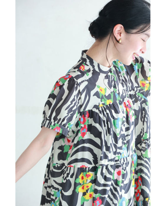 A long dress with a pop floral pattern overlapping with swaying art