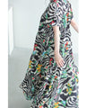 A long dress with a pop floral pattern overlapping with swaying art