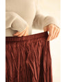A long skirt with a velour-like texture and a wrinkled, washed look