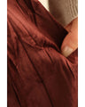 A long skirt with a velour-like texture and a wrinkled, washed look