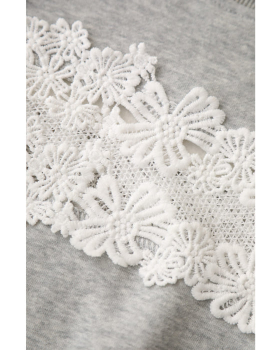 Fleece-lined pullover top with flowing white floral lace