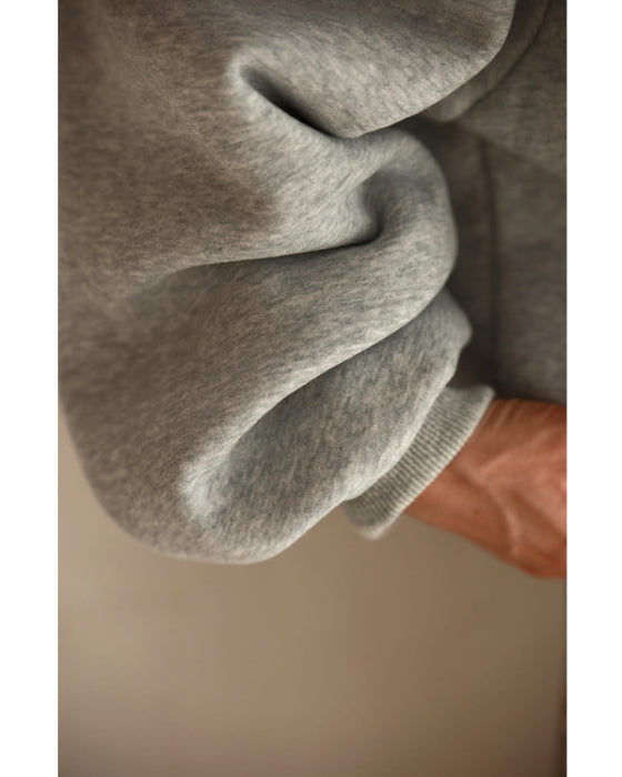 Fleece-lined pullover top with flowing white floral lace