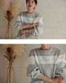 Fleece-lined pullover top with flowing white floral lace