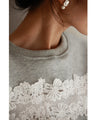 Fleece-lined pullover top with flowing white floral lace