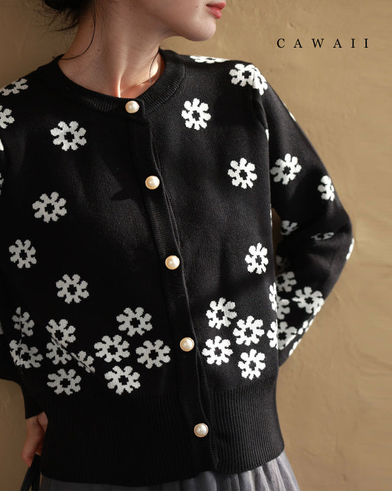 A knitted cardigan with falling white flowers