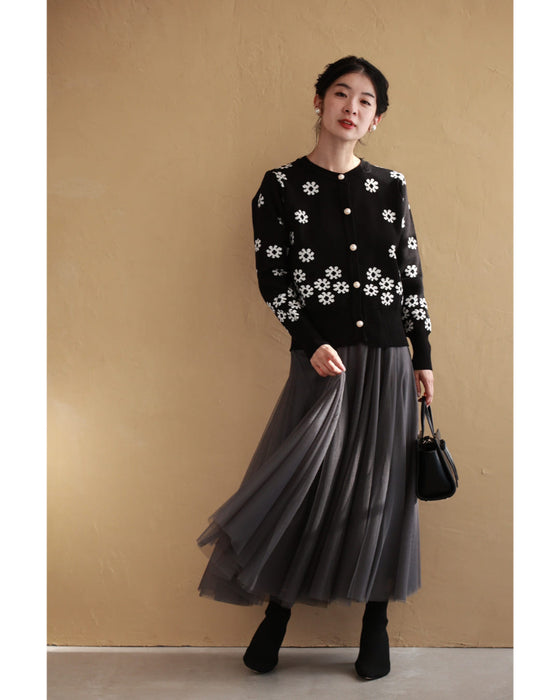 A knitted cardigan with falling white flowers