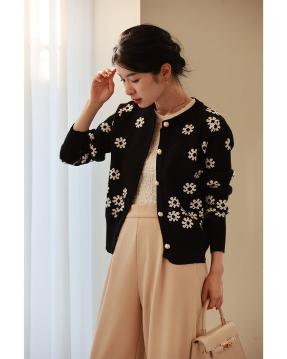 A knitted cardigan with falling white flowers
