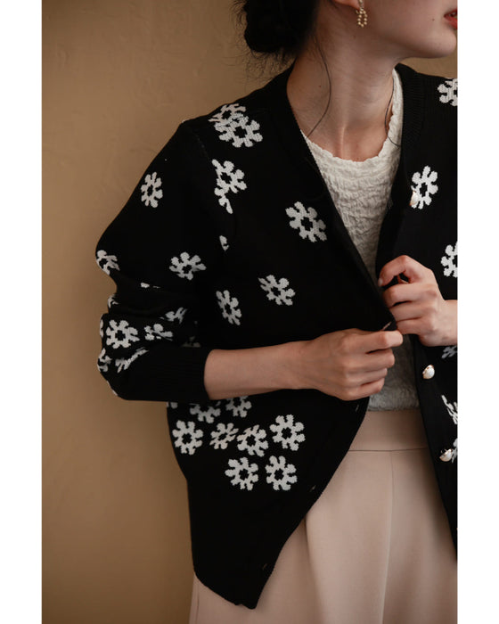 A knitted cardigan with falling white flowers