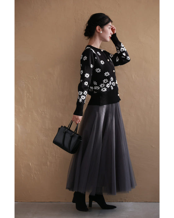 A knitted cardigan with falling white flowers