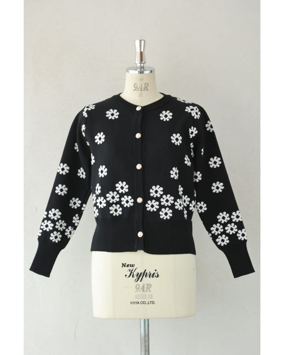 A knitted cardigan with falling white flowers