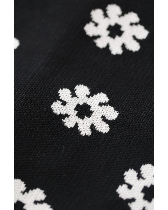 A knitted cardigan with falling white flowers