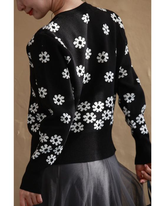 A knitted cardigan with falling white flowers