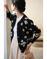 A knitted cardigan with falling white flowers