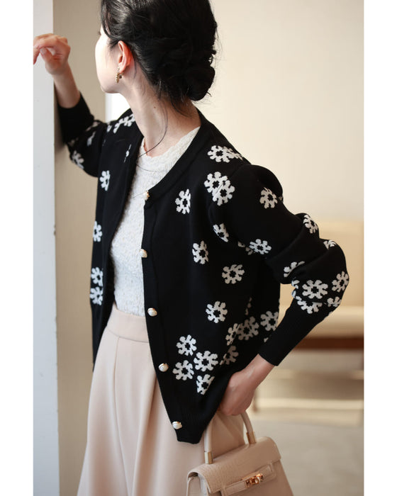 A knitted cardigan with falling white flowers