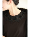 A pullover top with three-dimensional rose lace that brightens up the décolletage
