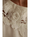 A pullover top with three-dimensional rose lace that brightens up the décolletage