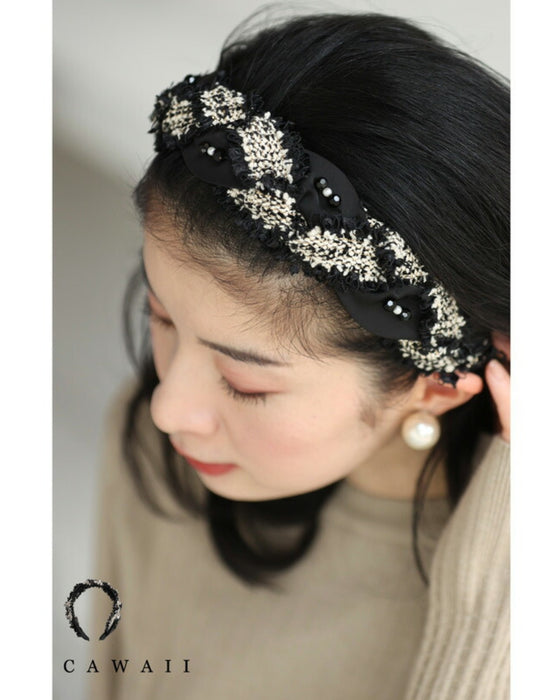 A twisted headband made of different materials and decorated with jewels