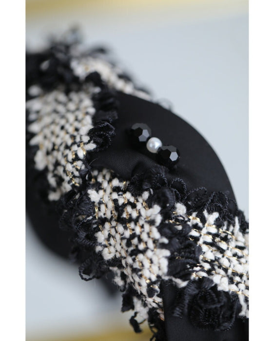 A twisted headband made of different materials and decorated with jewels