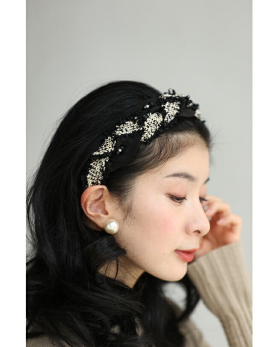 A twisted headband made of different materials and decorated with jewels