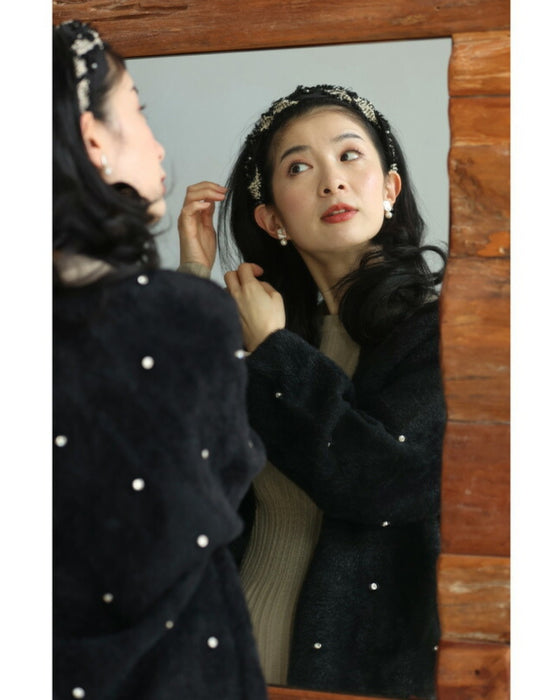 A twisted headband made of different materials and decorated with jewels