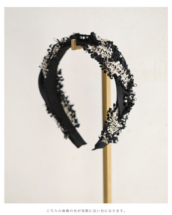 A twisted headband made of different materials and decorated with jewels
