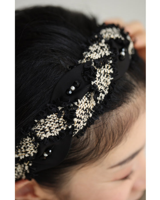 A twisted headband made of different materials and decorated with jewels