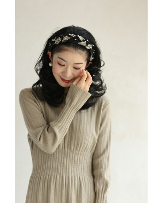 A twisted headband made of different materials and decorated with jewels