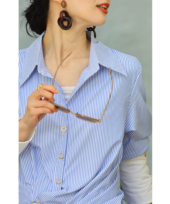 Asymmetrical draped shirt tunic fluttering in the fresh breeze