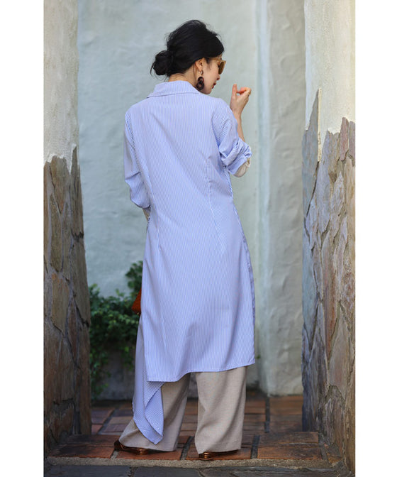 Asymmetrical draped shirt tunic fluttering in the fresh breeze