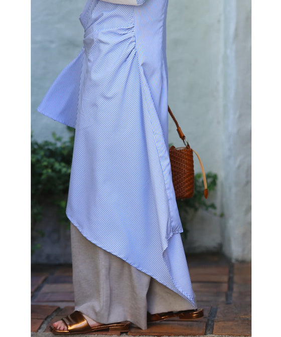 Asymmetrical draped shirt tunic fluttering in the fresh breeze