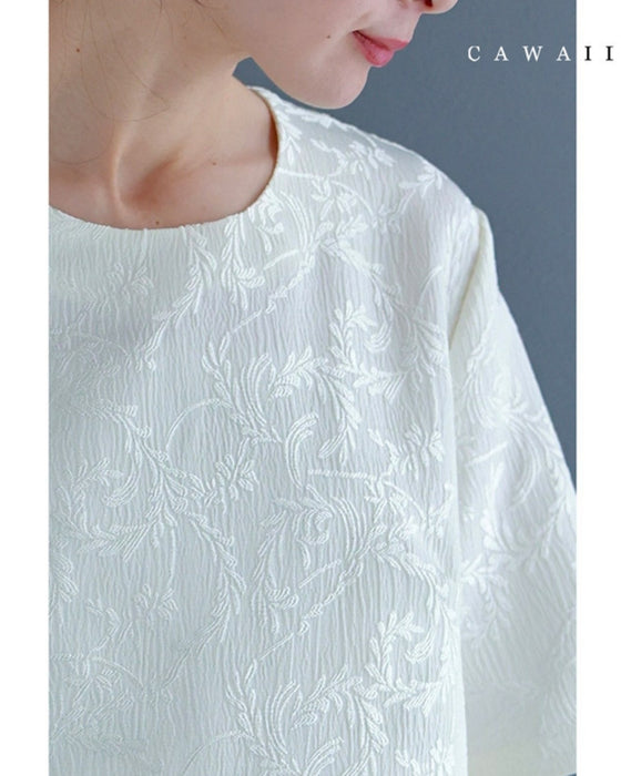 Pullover top with floating leaf pattern and relief effect
