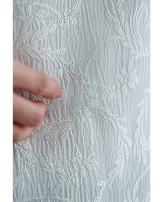 Pullover top with floating leaf pattern and relief effect