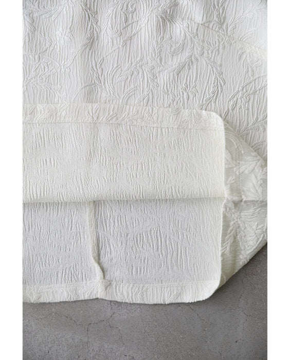 Pullover top with floating leaf pattern and relief effect