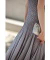 A mid-length dress with a voluminous skirt and waistline