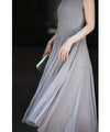A mid-length dress with a voluminous skirt and waistline