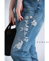 Denim pants with rhinestones and embroidered flowers