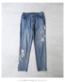Denim pants with rhinestones and embroidered flowers