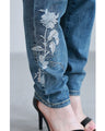 Denim pants with rhinestones and embroidered flowers