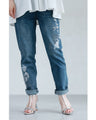 Denim pants with rhinestones and embroidered flowers