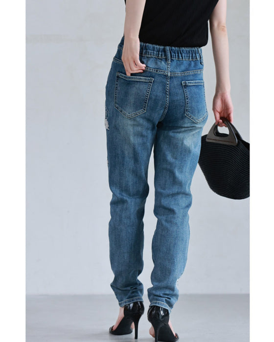 Denim pants with rhinestones and embroidered flowers