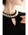 A medium-length velour-like dress with a pearl neck that wraps around you