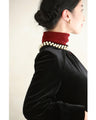 A medium-length velour-like dress with a pearl neck that wraps around you