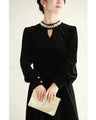A medium-length velour-like dress with a pearl neck that wraps around you