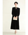 A medium-length velour-like dress with a pearl neck that wraps around you